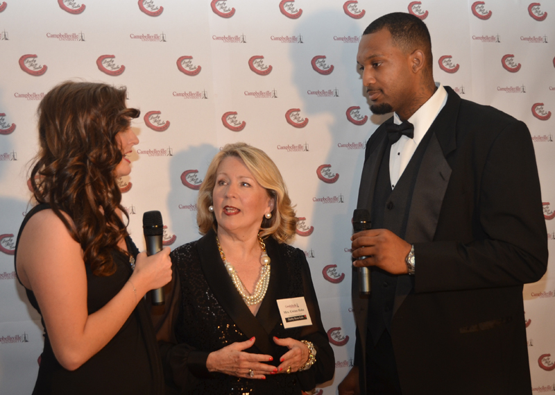 Kinly Bertram, left, and A'Darius Pegues, right,  interview Gwinn Hahn, chair of the gala, during the live broadcast. (Campbellsville University Photo by Bethany Thomaston)
