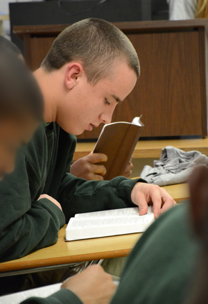  Combs, a teen from Lincoln Village  Juvenile Detention Center, reads scripture  out loud during a Bible conference hosted  by a CU sports ministry class. (Campbellsville University Photo by Christina L. Kern)