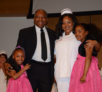LaShella Caldwell of Campbellsville, Ky., was pinned by her father, Michael Caldwell, and two daughters, Laneysa and Lavonya. (Campbellsville University Photo by Christina Kern)