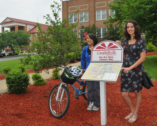 The new ‘you are here’ map located in front of the Campbellsville University Administration Building is graced by the presence of two summer school students. At left is Julia Tan, a junior from Malaysia studying psychology; and at right is Gokce Korkut, a junior from Turkey studying macro and micro economics. (Campbellsville University Photo by Linda Waggener)