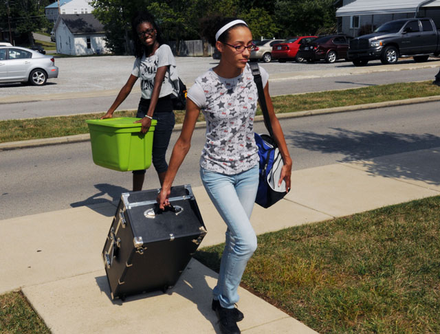 Jasmine Graham, left, and Myra Rose, both of Louisville, carry their belongings into their new home in the Women’s Residence Village at Campbellsville University. They are roommates who are also on the cross country team together. (Campbellsville University Photo by Richard RoBards)