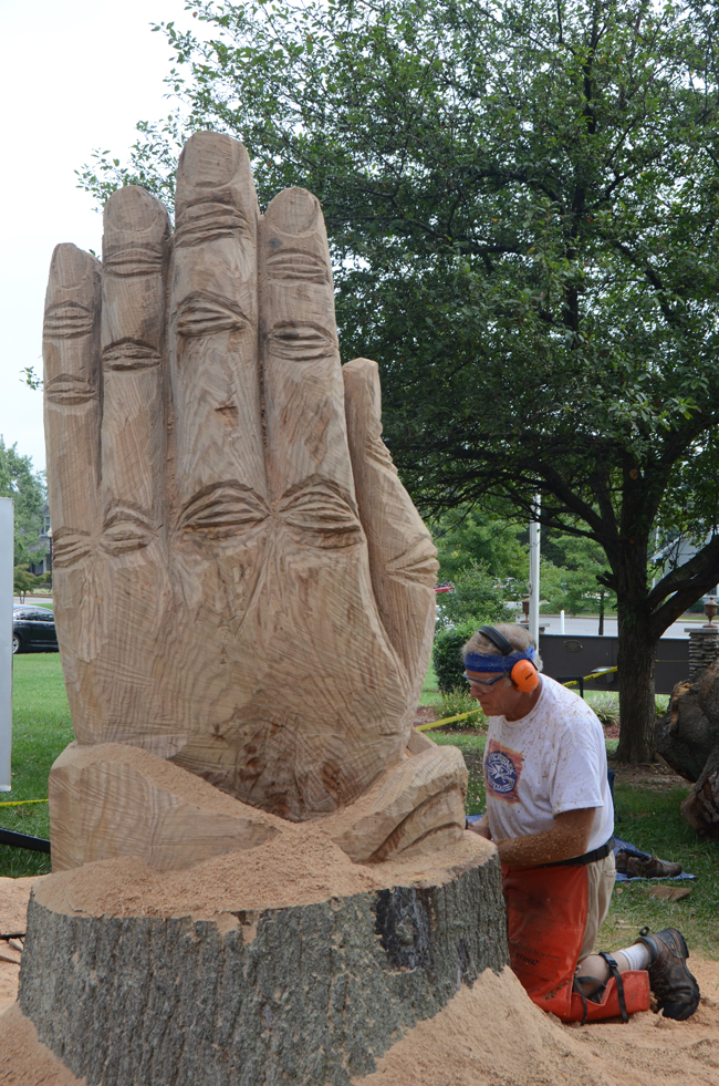 Rob Peterson, a Louisville artist, continues work Monday on the praying hands he has designed on Stapp Lawn. He is an independent worker and a full-time remodeler and builder. Peterson does his own designs, but he uses photos and others' ideas to inspire his work. (Campbellsville University Photo by Kyle Perkins)