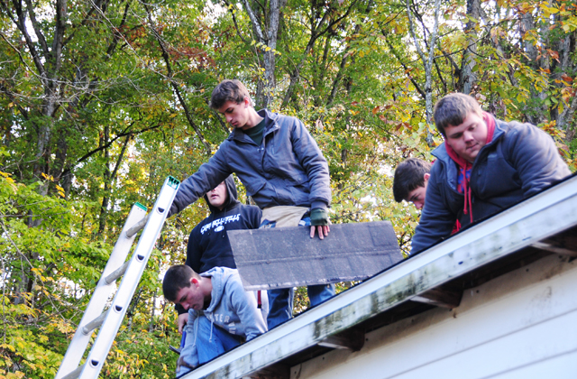 Students work on a repairing a roof at "Repair Affair" at Campbellsville University. (Campbellsville University Photo by Kasey Ricketts)