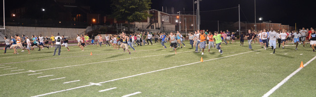  CU students run across the football field at Finley Stadium as part of the attempt to beat the world record in Red Light/Green Light. (Campbellsville University Photo by Naranchuluu Amarsanaa)