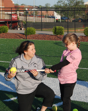 CU senior softball player, Jennifer England, shows  Molly Hughes how to hit the ball. Both are from  Campbellsville. (Campbellsville University Photo by Lacy Mudd)