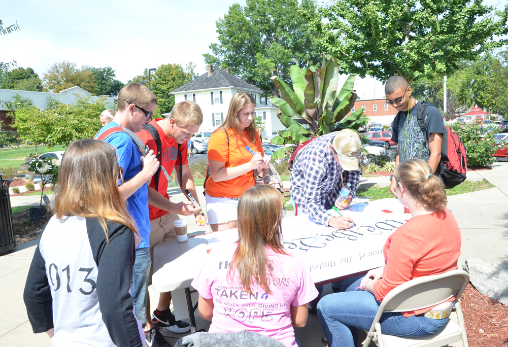 The CU Student Government Association started the 2013     Constitution Day with students signing a blown up version of  the Constitution of the United States. They were then given a  smaller version to take home. (Campbellsville University  Photo by Ye Wei "Vicky")