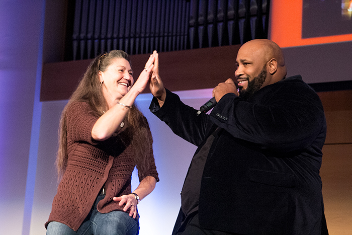 Montre Davis, on right, picks Sandra Peters from the audience and sings a song for her birthday. She is from Cecilia, Ky. (Campbellsville University Photo by Joshua Williams)