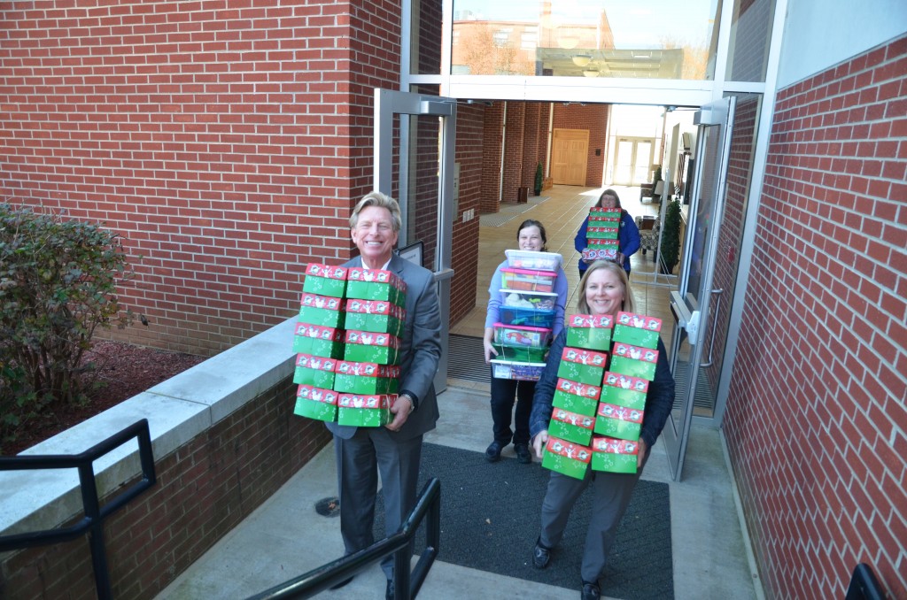 From left Dr. G. Ted. Taylor, Heather Sabo Graham, Dr. Marilyn Goodwin, and Sherry Bowen help carry Operation Christmas Child boxes to the truck. (Campbellsville University Photo by Joan C. McKinney)