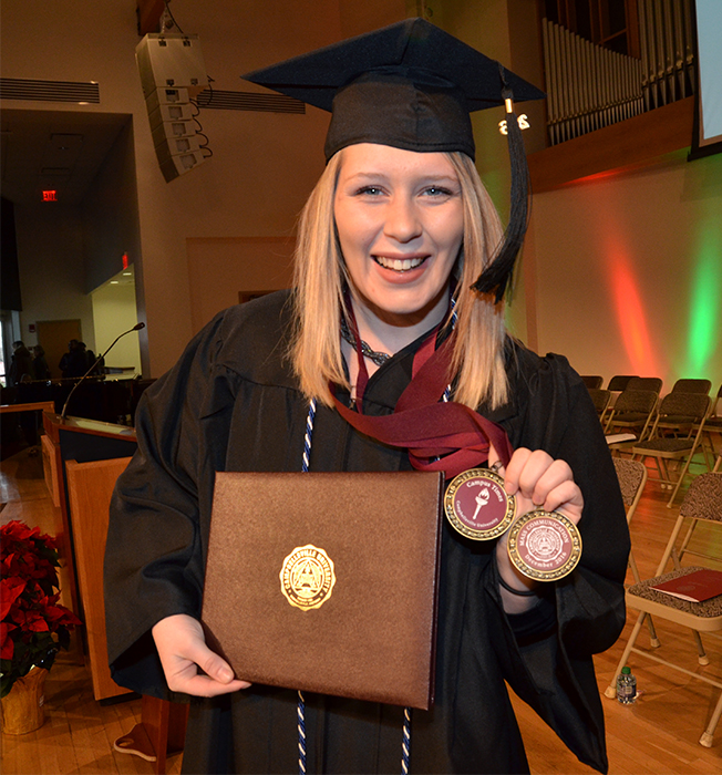 Kasey Ricketts, shows her Mass Communication medals. (Campbellsville University Photo by Joshua Williams)