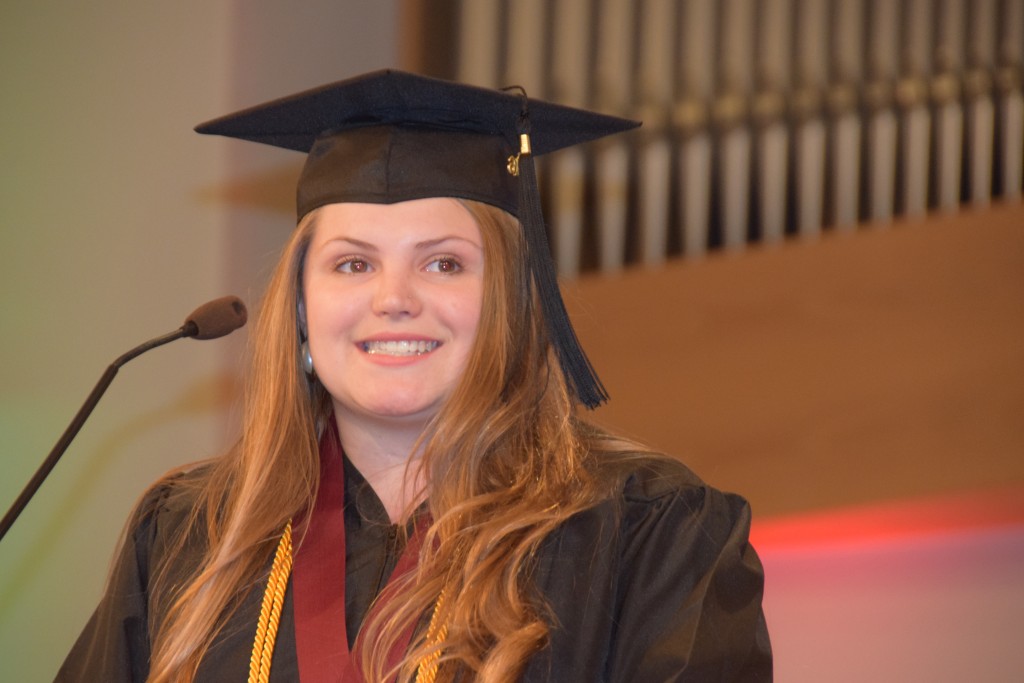 1-As class speaker, Shelby Knuckles accepts the charge set forth by Campbellsville University President Michael V. Carter. (Campbellsville University Photo by Drew Tucker)