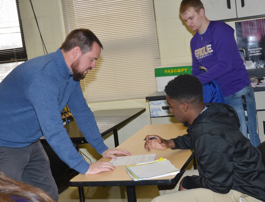 Scott Necessary, director of dual credit at CU, talks to CHS junior Chanson Atkinson about his dual credit application.