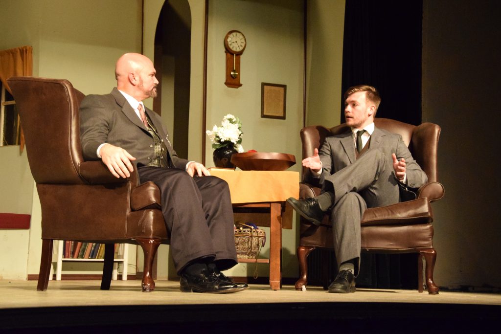 Les Chadwick, as Dr. Stockmann, talks with Tanner Reed of Campbellsville, who plays Hovstad, in “An Enemy of the People.” (Campbellsville University Photo by Shelby Hall)