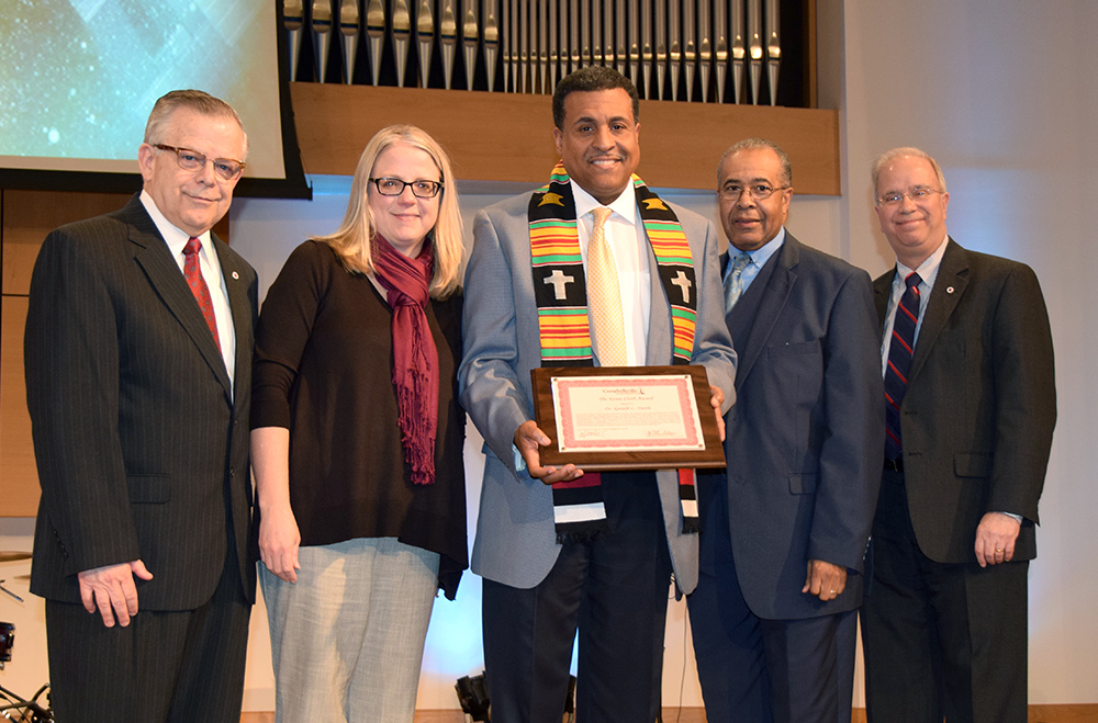 Dr. Gerald L. Smith, center, was awarded the CU Kente Cloth, given to those who have exemplified extraordinary servant leadership, after speaking at Campbellsville University's traditional Martin Luther King chapel service. From left in the presentation are: John Chowning, executive assistant to the president for government, community and constituent relations; Dr. Donna Hedgepath, vice president for academic affairs and professor of education; Dr. Joseph L. Owens, former CU board of trustee's chair; and Dr. Michael V. Carter, president.