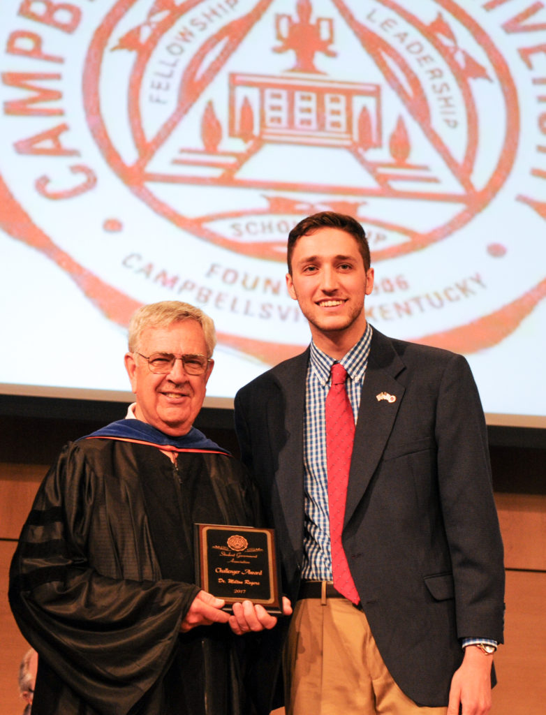 Dr. Milton Rogers, left, professor of biology at Campbellsville University, receives the Challenger Award from Aaron Nosich, president of the Student Government Association at Campbellsville University. (Campbellsville University Photo by Joshua Williams)
