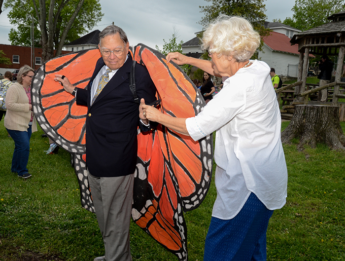 Susie Walters, on right, helps George Howell, to put on the butterfly wings at the Earth Day ceremony at Campbellsville University. ((Campbellsville University Photo by Tomomi Sato) 