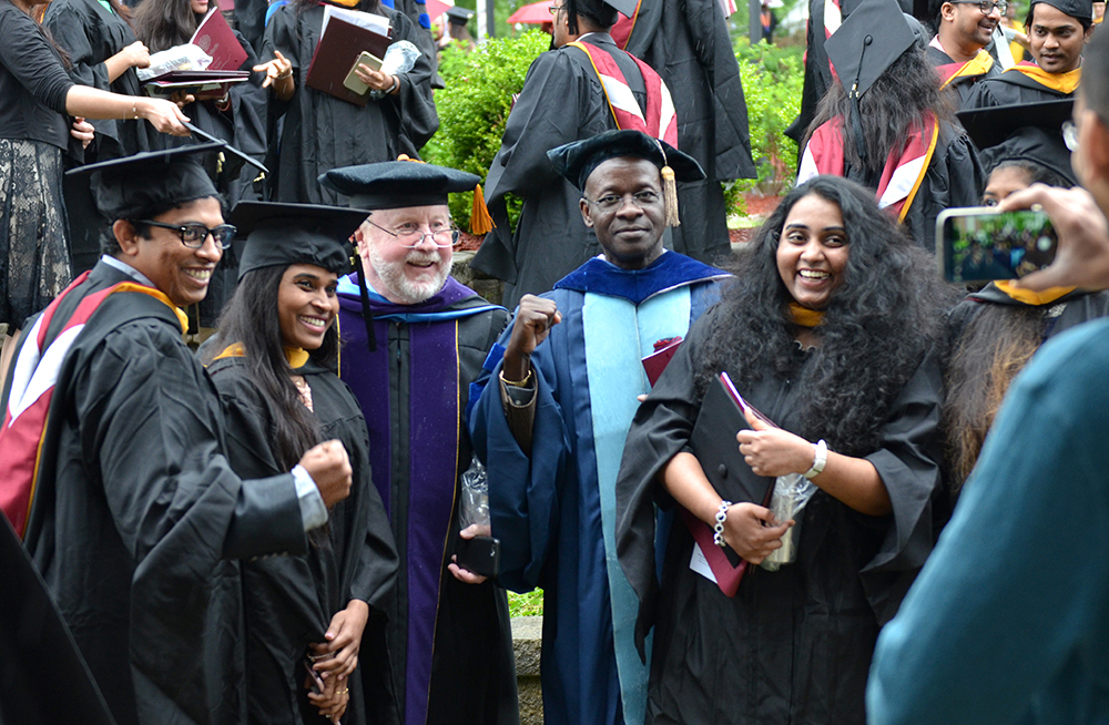 Master of Science in Information Technology and Management graduates take photos with their professors after the commencement ceremony at Ransdell Chapel. From left are: Sai Kiran Gadde, Srilekha Allamsetty, Bruce Singleton, assistant professor of business, Dr. Sunny Onyiri, professor of business and accounting and director of the business program at Louisville Education Center; and Nikhita Pavani. (Campbellsville University Photo by Joshua Williams)