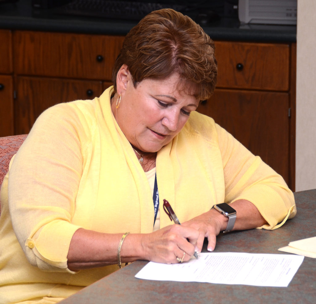 Jane Wheatley, chief executive officer at Taylor Regional Hospital, signs a partnership agreement between TRH and Campbellsville University. (Campbellsville University Photo by Joshua Williams)