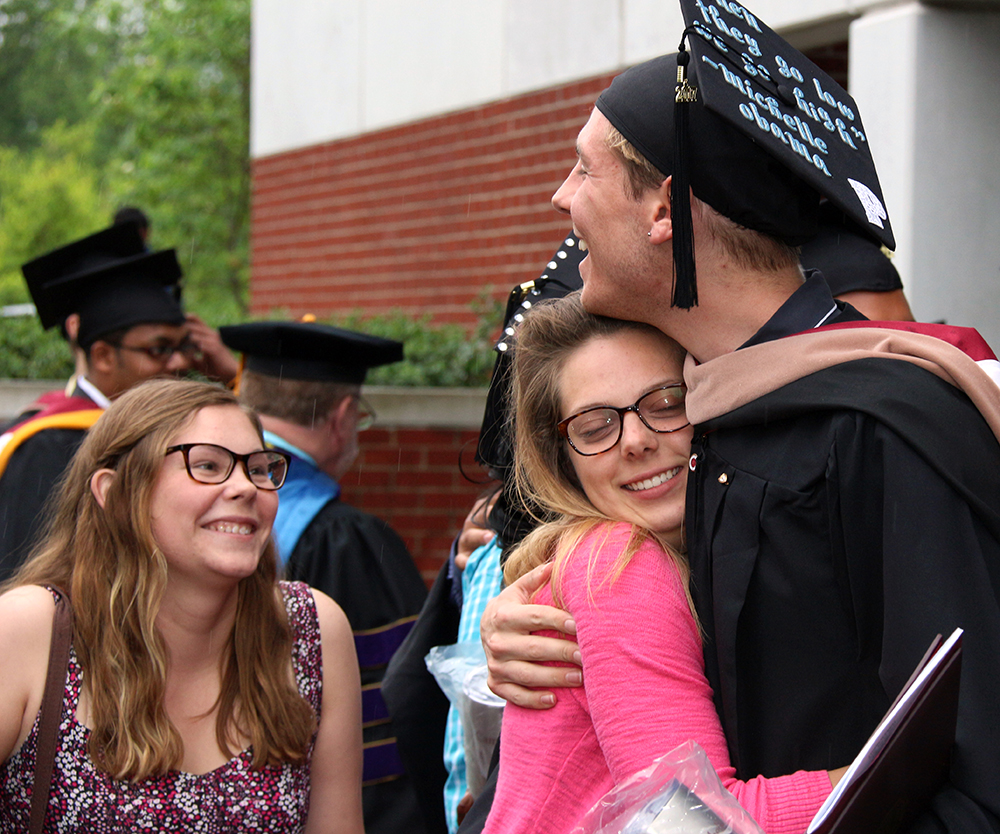 Katy Lewis of North Augusta, S.C. and Katie Miller of Fayetteville, Ga. congratulates Patrick Sonsteng of Campbellsville graduating with his master’s degree. (Campbellsville University Photo by Drew Tucker) 