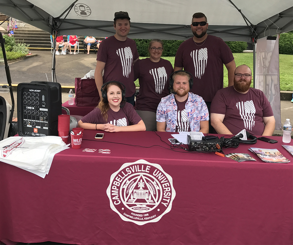 The Tiger Team at 88.7 FM covers the parade at 10 a.m. at the Campbellsville/Taylor County annual Fourth of July celebration. From left, front, are Jess McCandless of Elizabethtown, Ky.;  Alex Meade of Paintsville, Ky. and Andrew Bennett, coordinator of audio/visual services. Back, Matt Wehle of Mechanicsville, Va., Jeannie Clark, director of broadcast services, and Matt Payton, radio program/production director. (Campbellsville University Photo by Joan C. McKinney)