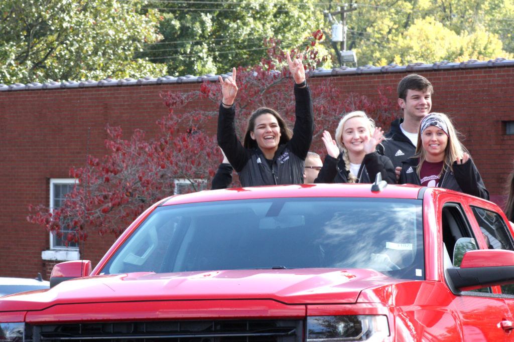From left, Kayla Miracle, Taylor Blevins, Randal Parmley and Jessica Howard, CU cheerleaders, ride on a float during the 2017 Homecoming Parade at downtown Campbellsville. (Campbellsville University Photo by Andrea Burnside)