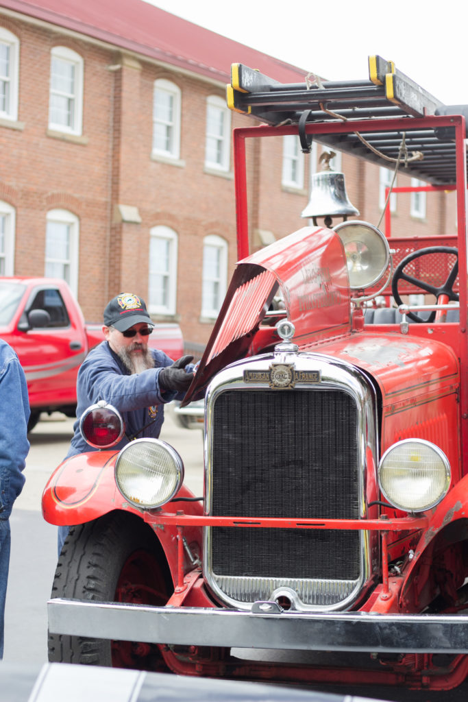 Randy Bricken Jr., shows off the engine of the 1932 fire truck during the Car Cruise at 2017 Homecoming at Campbellsville University. (Campbellsville University Photo by Joshua Williams)