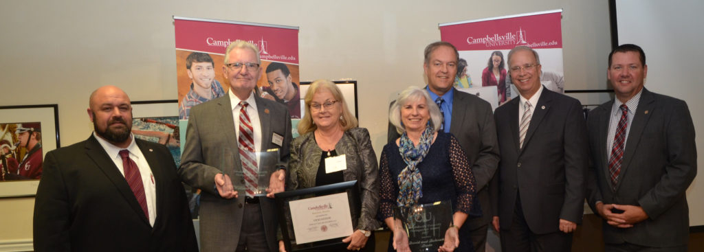 B.J. Senior, (’68), second from left, was awarded the Distinguished Alumnus Award at the Homecoming reception Friday night, Oct. 27. His wife, Vicki, was given an Honorary Alumnus Award. Debby Hazelip Duda (’82) and her husband, Dave (’77), were also given Distinguished Alumni Awards. Making the presentations were, from far left, Darryl Peavler, director of alumni relations; Dr. Michael V. Carter, president; and Benji Kelly, vice president for development. (Campbellsville University Photo by Joan C. McKinney)