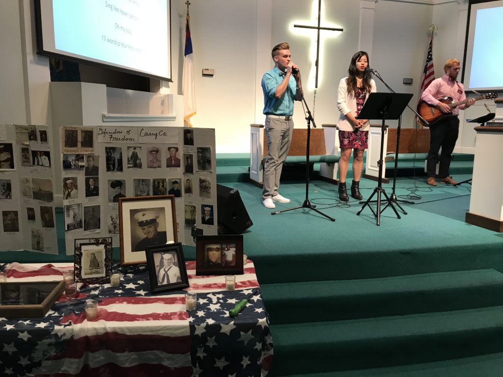 Liberty United Methodist Church welcomed Campbellsville University Church Outreach Sunday. From left, Connor Mattingly, freshman vocalist from Lebanon, Ky.; Chimrila Quinker, freshman vocalist from India; and Devan Bishop, church outreach music coordinator, played music at Liberty United Methodist Church as the church celebrated Veterans Day with a display of pictures and candles lit for the veterans. Veterans present were also recognized and thanked for their service. (Campbellsville University Photo by Joan C. McKinney)