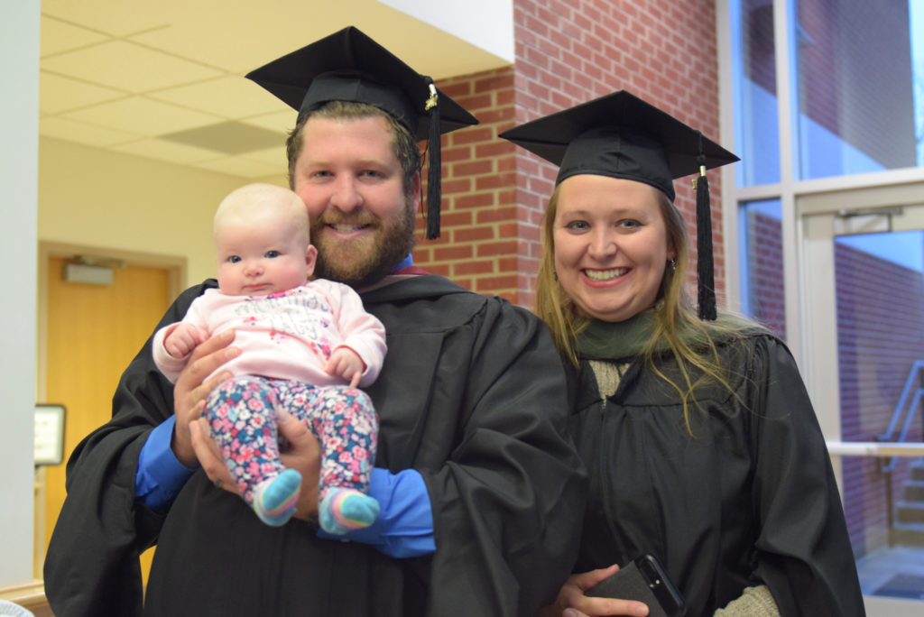 Brandon Lakes, left, resident director of South Hall West, and Hillary Lakes, head coach for cross country, with their daughter, Haily, celebrate after they receive their master’s degrees at Campbellsville University. (Campbellsville University photo by Andrea Burnside)